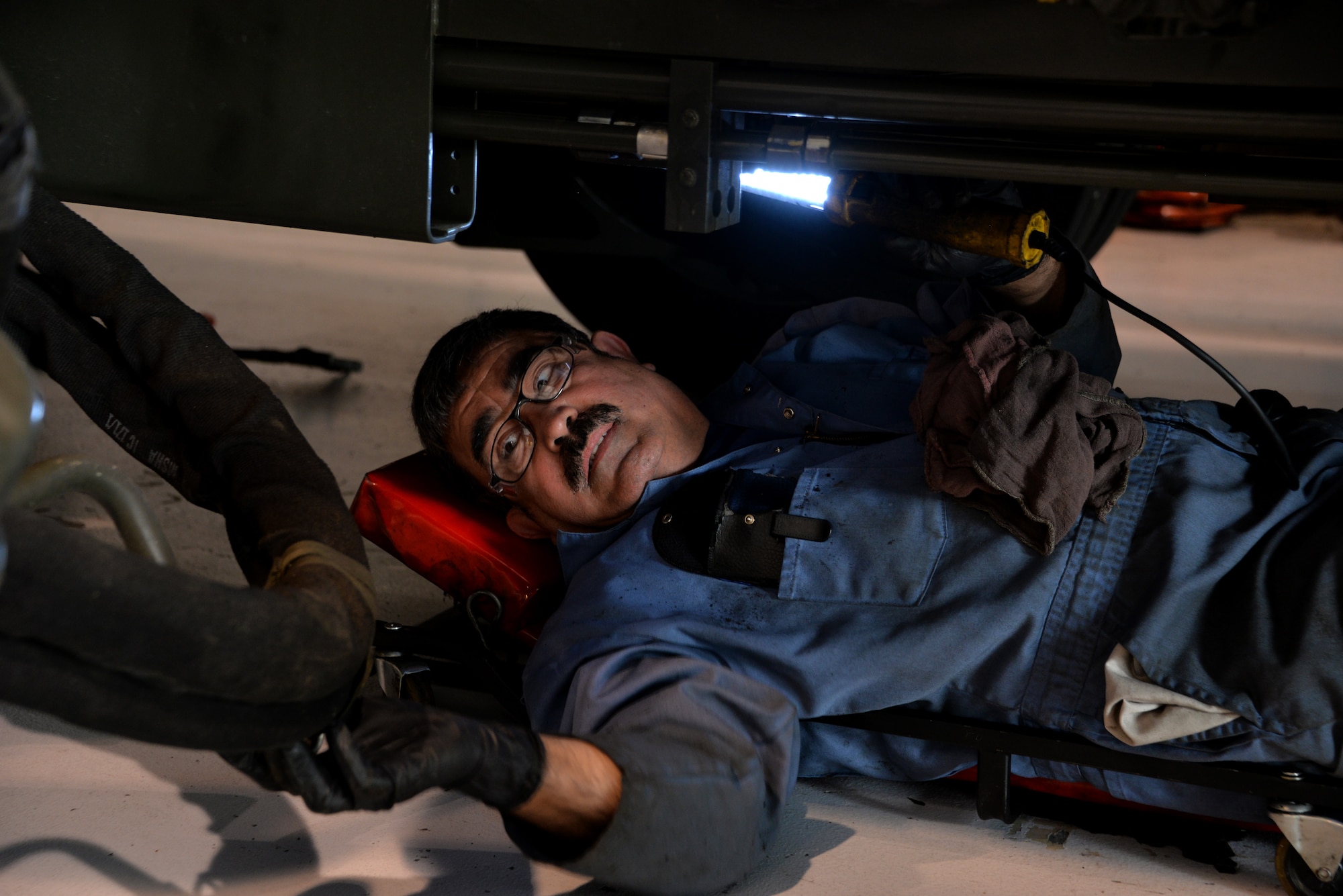 Armando Chavarria, 60th Logistics Readiness Squadron heavy vehicle mechanic, inspects a Tunner 60K aircraft loader's isolation valves for war April 26 at Travis Air Force Base, Calif. Travis has a total of 17 Tunner 60K aircraft loaders supporting aerial port squadron operations, the largest 60K loader fleet in the Air Force. (U.S. Air Force photo by Staff Sgt. Charles Rivezzo)