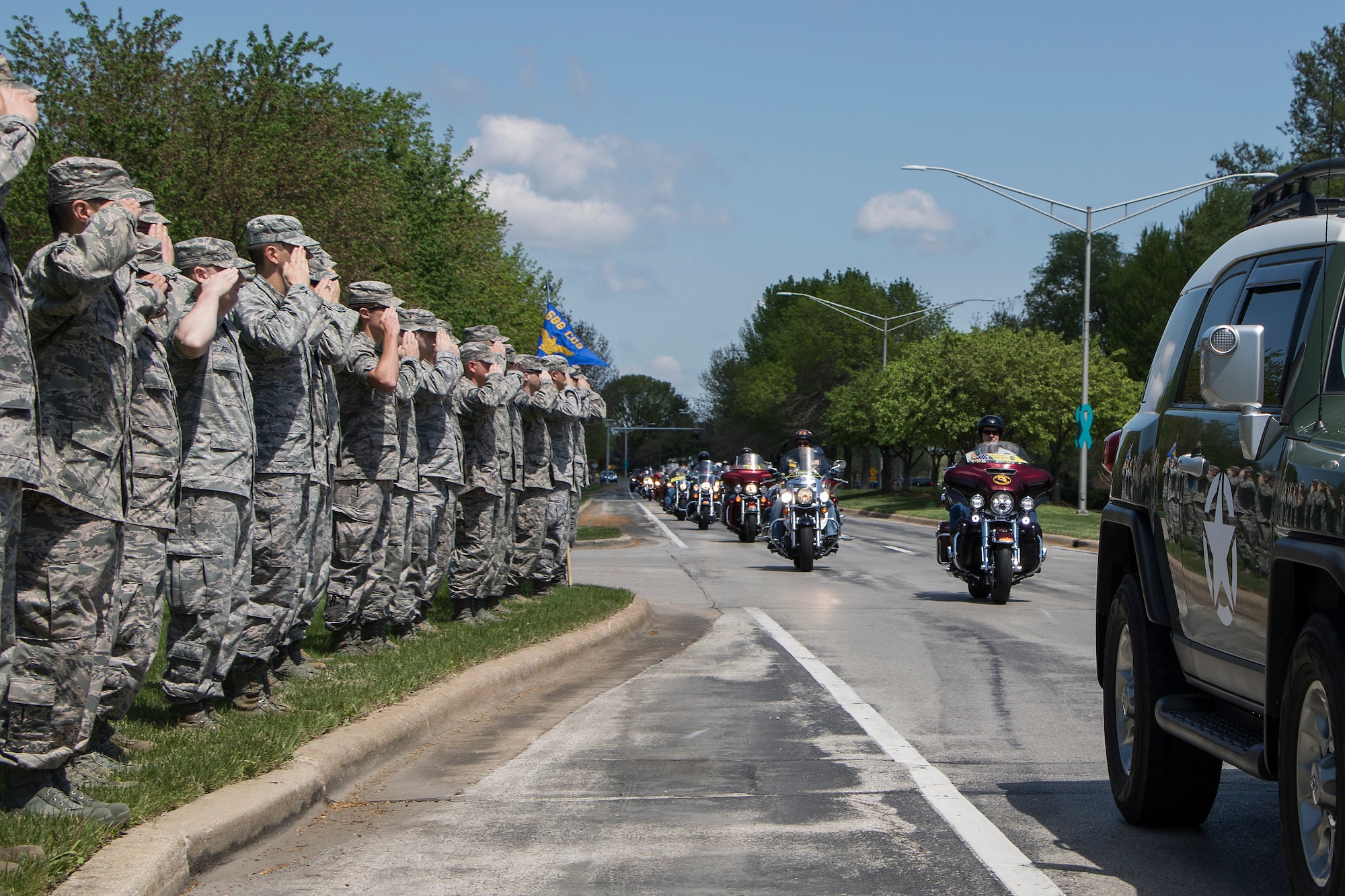 Members of Team Scott salute Vietnam Veteran and retired Army Sgt. Cecil Wade as he leads a formation of Combat Vets Motorcycle Association and Patriot Guard riders April 22 at SAFB. Wade led the formation to a ceremony, where he was awarded the Purple Heart, the Army Commendation Medal with Valor and a second bronze star device for his Vietnam Service Medal. The ceremony was spearheaded by friends and fellow riders, Master Sgts. John and Brenda Roskom. (U.S. Air Force photo by Tech. Sgt. Jonathan Fowler)