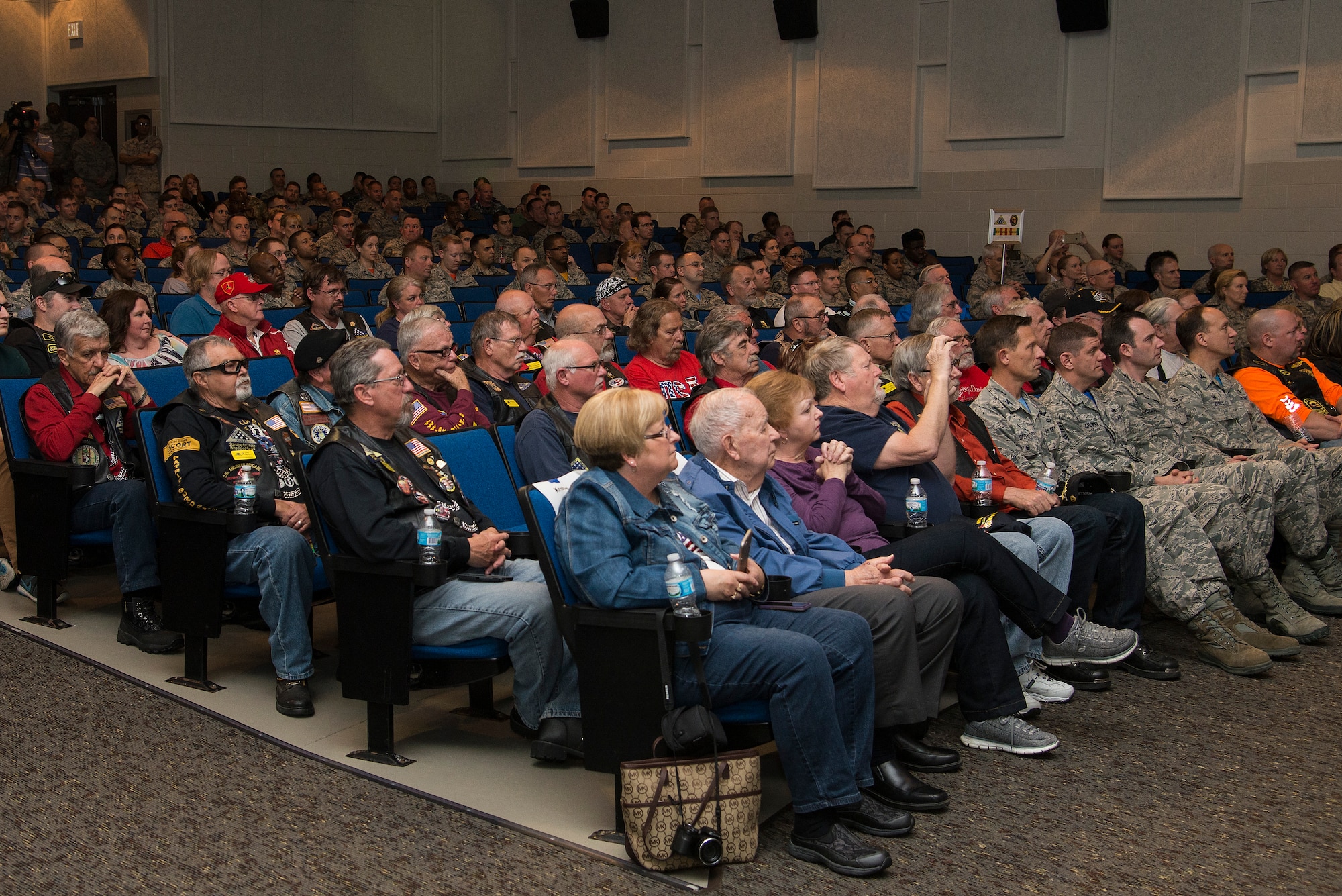 A crowd of people watch and wait for Retired Army SGT. Wade to be presented his Purple Heart. The Purple Heart is a combat medal awarded to members of the armed forces who are wounded by an instrument of war in the hands of the enemy. (Air Force photo by Airman 1st Class Gwendalyn Smith)