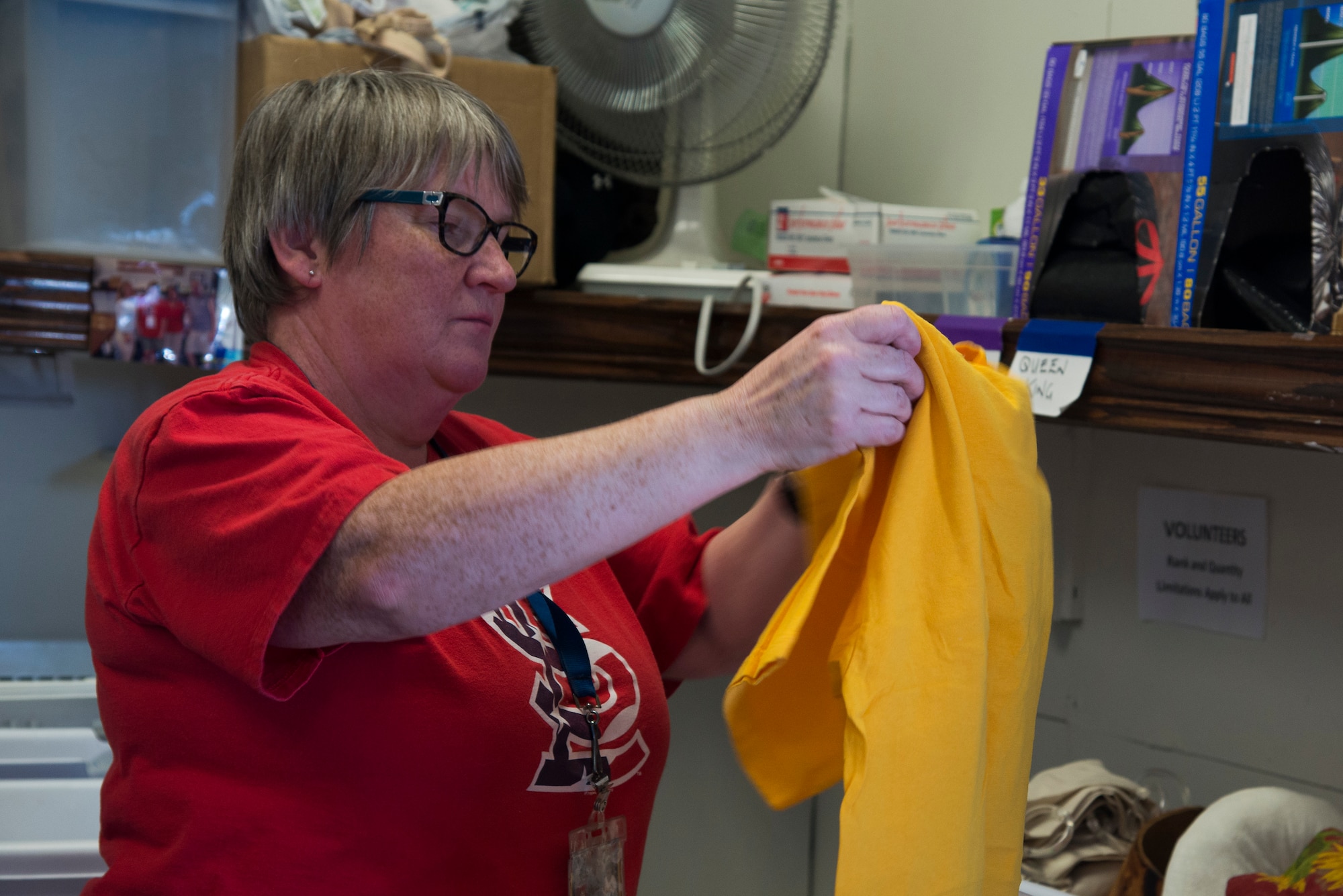 Sandra McKenney, a Chief Master Sgt. Gene Airman’s Attic core volunteer, sorts clothes into baskets April 12, 2016 at Scott Air Force Base, Ill. The Airman’s attic is open Tuesdays and Thursdays from 9-11 a.m., and the first Saturday of the month from 9 a.m. to noon. Items can be donated Tuesdays and Thursdays from 8:30-11:30 a.m. and the first Saturday of the month from 8:30 a.m. to noon. (U.S. Air Force photo by Airman 1st Class Gwendalyn Smith)