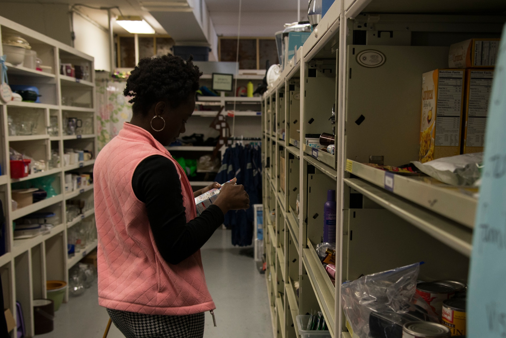 A shopper looks through the different shelves at the Chief Master Sgt. Gene Collins Airman’s Attic April 12, 2016 at Scott Air Force Base, Ill. The Airman’s Attic was named after CMSgt Gene Collins in 2010. Collins became the manager of the facility in 2004 with a goal to better take care of Scott's Airmen. (U.S. Air force photo by Airman 1st Class Gwendalyn Smith)