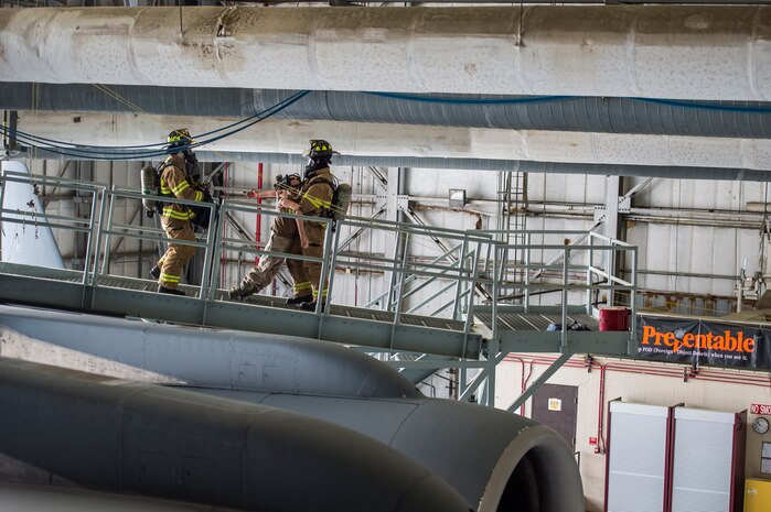 Airmen from the 628th Civil Engineer Squadron fire emergency services flight rescue a “victim” during a confined space emergency extraction exercise, April 22, 2016, at Joint Base Charleston, S.C. The exercise simulated a person losing consciousness inside one of the four fuel tanks aboard a C-17 Globemaster III. (U.S. Air Force photo/Staff Sgt. Jared Trimarchi) 