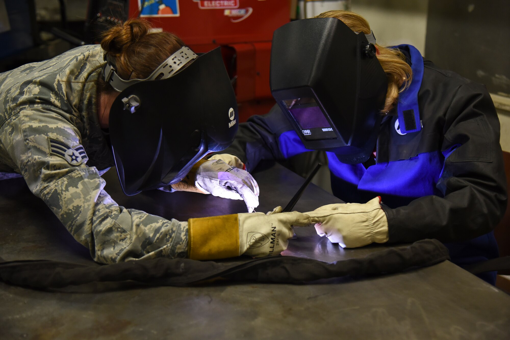 The Honorable Deborah Lee James, Secretary of the Air Force, completes a welding project April 27, 2016, at Fairchild Air Force Base 92nd Maintenance Squadron metals technology shop under the close supervision of Senior Airman Mary Cannon, 92nd MXS metals technology journeyman. James visited Fairchild to familiarize herself with the 92nd and 141st Air Refueling Wing and the 336th Training Group missions. (U.S. Air Force photo/Airman 1st Class Mackenzie Richardson)
