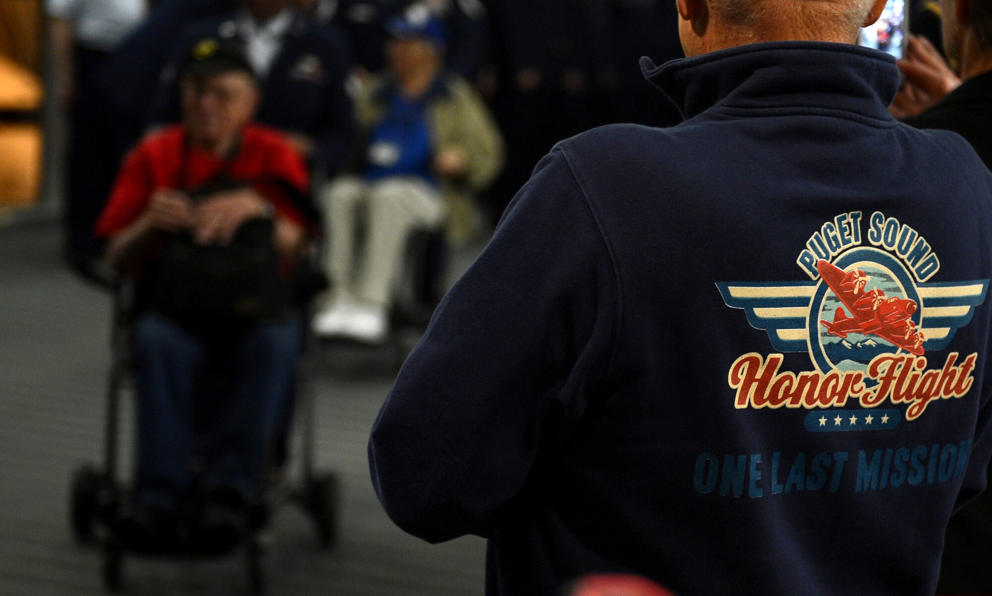 Members from the Puget Sound Honor Flight greet World War II Veterans upon their arrival to the SeaTac International Airport, Wash., April 25. The Puget Sound Honor Flight, which was established in March 2013 is a non-profit organization created solely to honor America's Veterans for their sacrifices. They transport military heroes to Washington D.C., to visit and reflect at the memorials. (U.S. Air Force photo/Senior Airman Divine Cox)