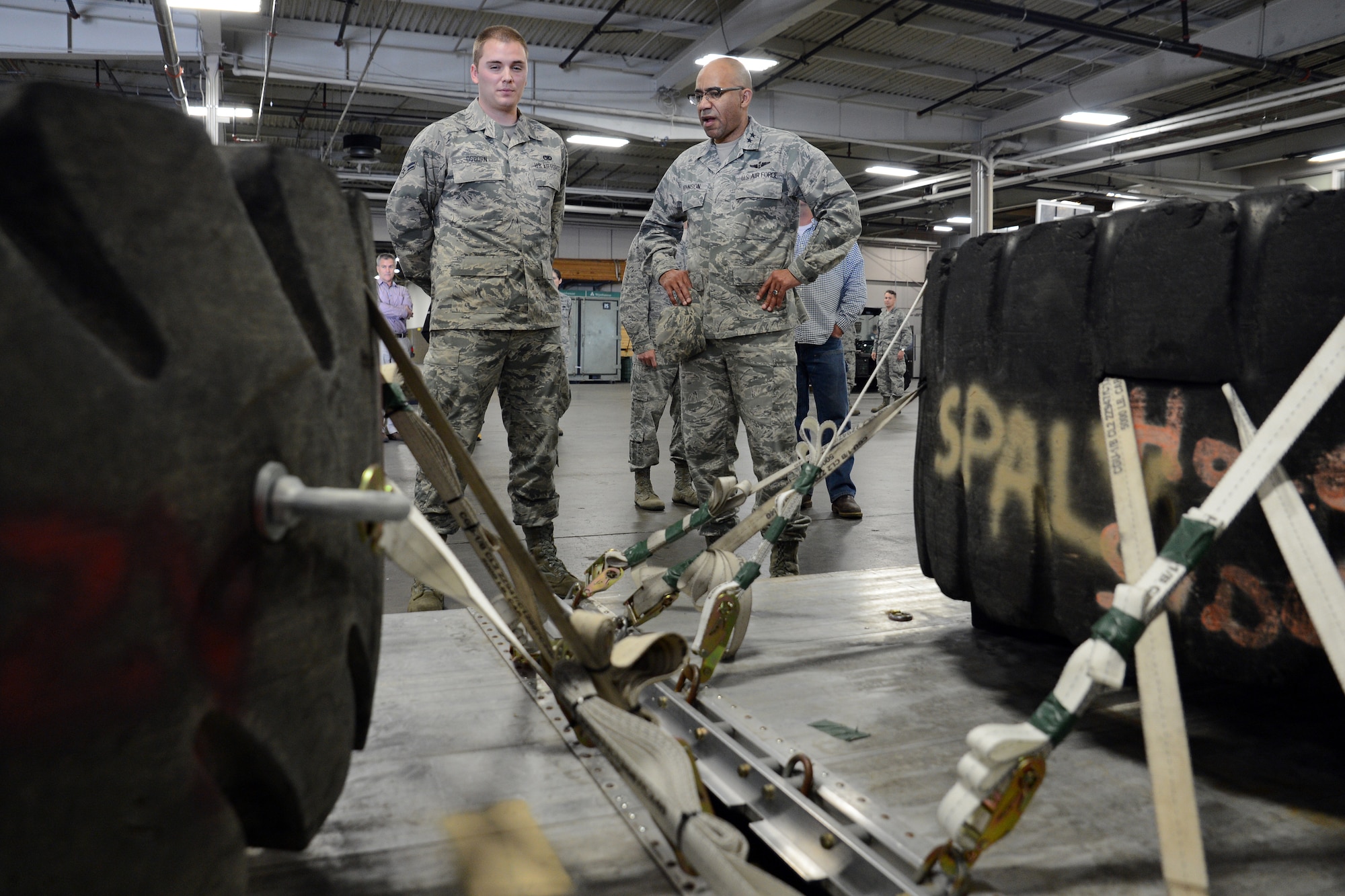 Maj. Gen. James Johnson, Air Force Sexual Assault Prevention and Response Office director, is briefed by Airman 1st Class Jacob Osborn, 62nd Aerial Port ramp services apprentice, about training pallets constructed by Osborn and other Airmen from the 62nd APS. Johnson served as the commander of the 62nd APS from Aug. 2002 to July of 2004. (U.S. Air Force photo/Senior Airman Jacob Jimenez) 