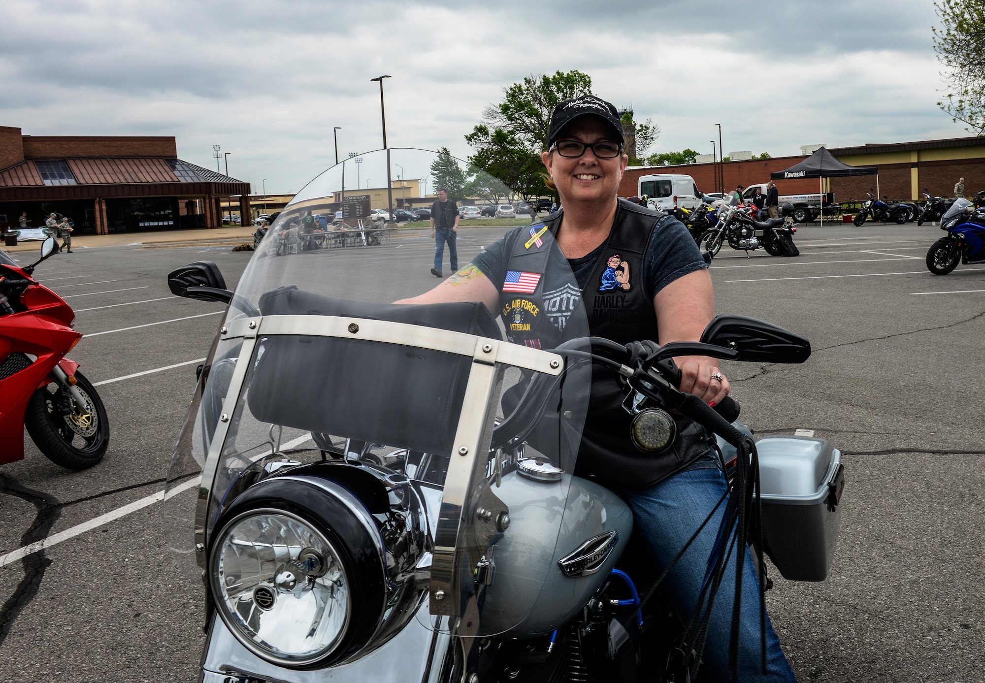 Sherry Duggan, a 72nd Test and Evaluation Squadron administrative support specialist, poses on her motorcycle during Motorcycle Safety Day at Whiteman Air Force Base, Mo., April 25, 2016. The 509th Safety Office held the event that offered information on available classes, a safety course with cones and opportunities for mentorship from experienced motorcyclists. (U.S. Air Force photo by Senior Airman Sandra Marrero)
