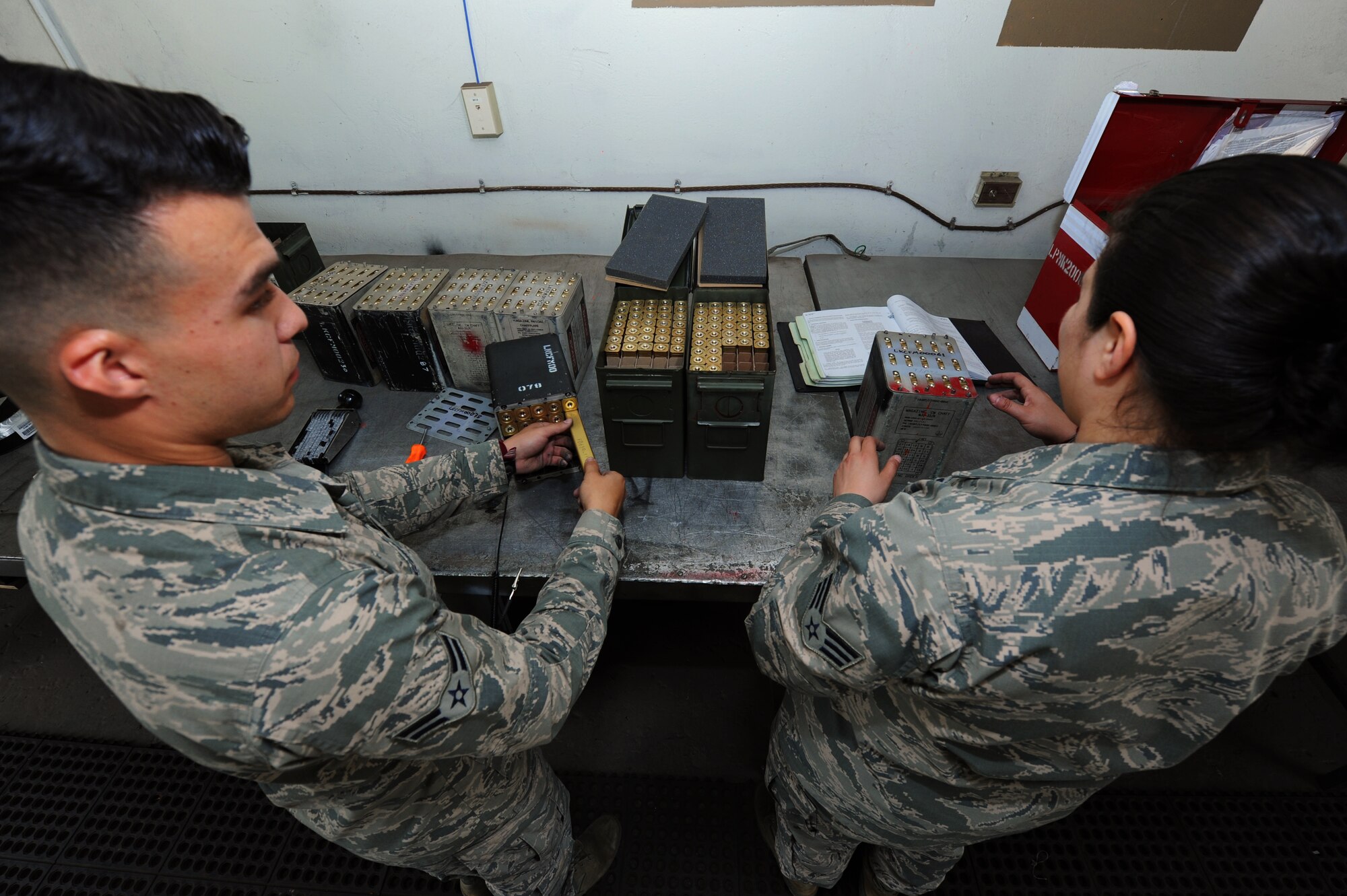 From left U.S. Air Force Senior Airman Micah Rodriguez and Airman 1st Class Alias C. Arzvaga, 19th Maintenance Squadron stockpile surveillance crewmembers, load flare sticks into containers April 21, 2016, at Little Rock Air Force Base. The 19th MXS munitions flight assembles, inspects and stores more than 1,400 types of weapons and ammunitions. (U.S. Air Force photo by Airman Kevin Sommer Giron)