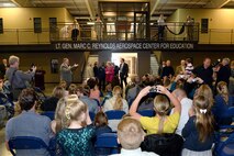 Guests applaud Ellie Reynolds, spouse of the late Lt. Gen. Marc C. Reynolds, during the ribbon cutting ceremony and grand opening of the newly constructed Lieutenant General Marc C. Reynolds Aerospace Center for Education April 27 at the Hill Aerospace Museum. The naming of the Lieutenant General Marc C. Reynolds Aerospace Center of Education recognizes an individual who served as Board Chair of the Aerospace Heritage Foundation of Utah for more than twenty years. The Reynolds Aerospace Center for Education, is partnering with local school districts providing additional co-curricular educational opportunities with elementary aged school children. Starting in the fall of 2016, additional children will visit the Hill Aerospace Museum and participate in hands-on activities that correspond directly with the Science curriculum of their particular grade. (U.S. Air Force photo by Todd Cromar)
