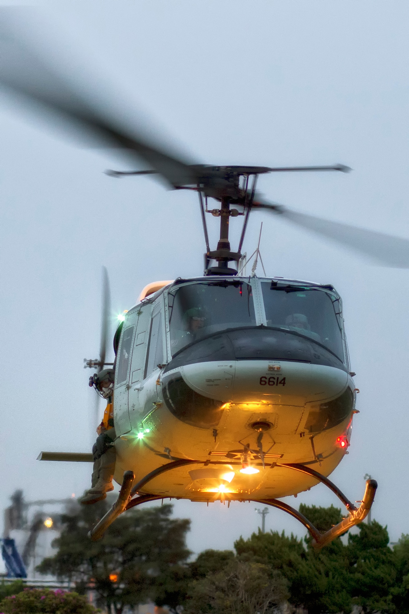 A UH-1N Iroquois assigned to the 459th Airlift Squadron takes off at U.S. Army Garrison Yokohama North Dock, April 25, 2016, during a training flight. The 459 AS regularly conducts training missions to remain proficient the necessary skills to support any contingency. (U.S. Air Force photo by Yasuo Osakabe/Released) 