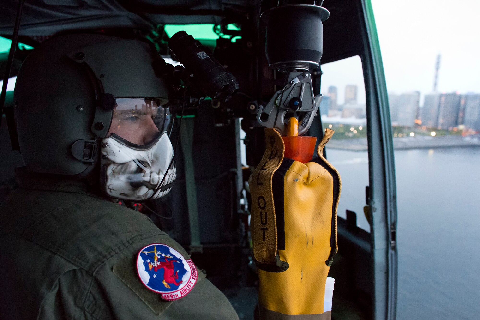Tech. Sgt. Christopher Rector, 459th Airlift Squadron UH-1N Iroquois special missions aviator evaluator, prepares to conduct hoist training over Yokohama bay, April 25, 2016, during a training flight. The 459 AS regularly conducts training missions to remain proficient the necessary skills to support any contingency. (U.S. Air Force photo by Yasuo Osakabe/Released) 