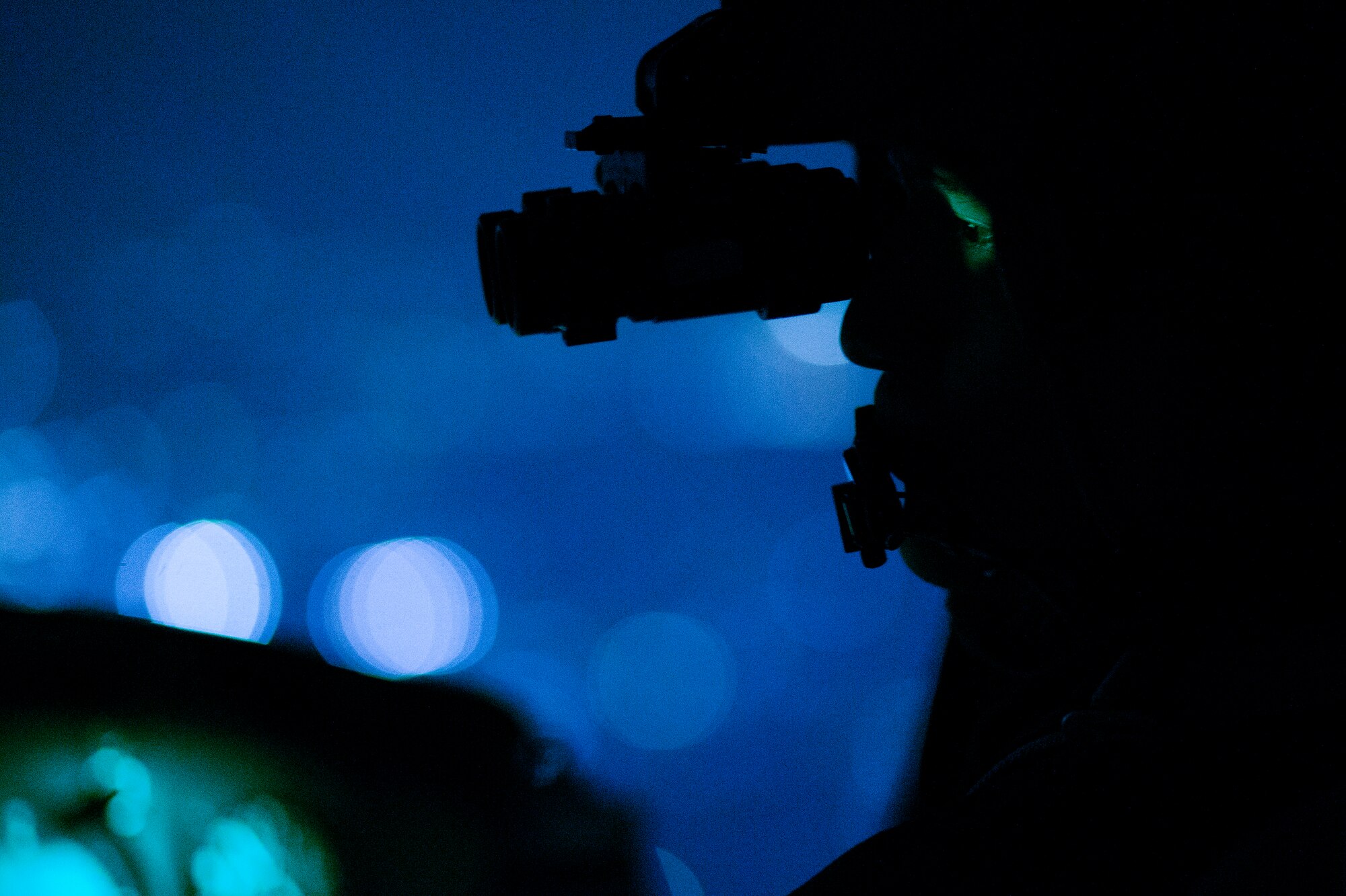 Capt. Jonathan Bonilla, 459th Airlift Squadron UH-1N pilot, performs a visual conformation using night vision goggles during a night training over Tokyo, April 25, 2016. The 459 AS frequently trains on a multitude of scenarios in order to stay prepared for potential real-world contingencies and operations. (U.S. Air Force photo by Yasuo Osakabe/Released)
