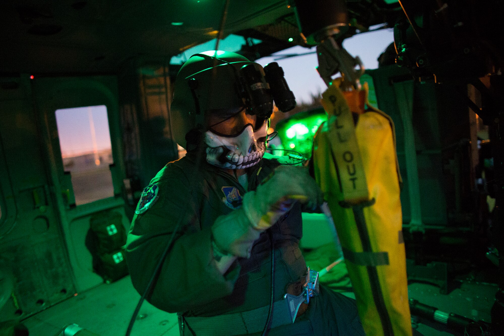 Tech. Sgt. Christopher Rector, 459th Airlift Squadron UH-1N Iroquois special missions aviator evaluator, secures a hoist during a training flight at U.S. Army Garrison Yokohama North Dock, April 25, 2016.  The 459 AS frequently trains on a multitude of scenarios in order to stay prepared for potential real-world contingencies and operations. (U.S. Air Force photo by Yasuo Osakabe/Released)