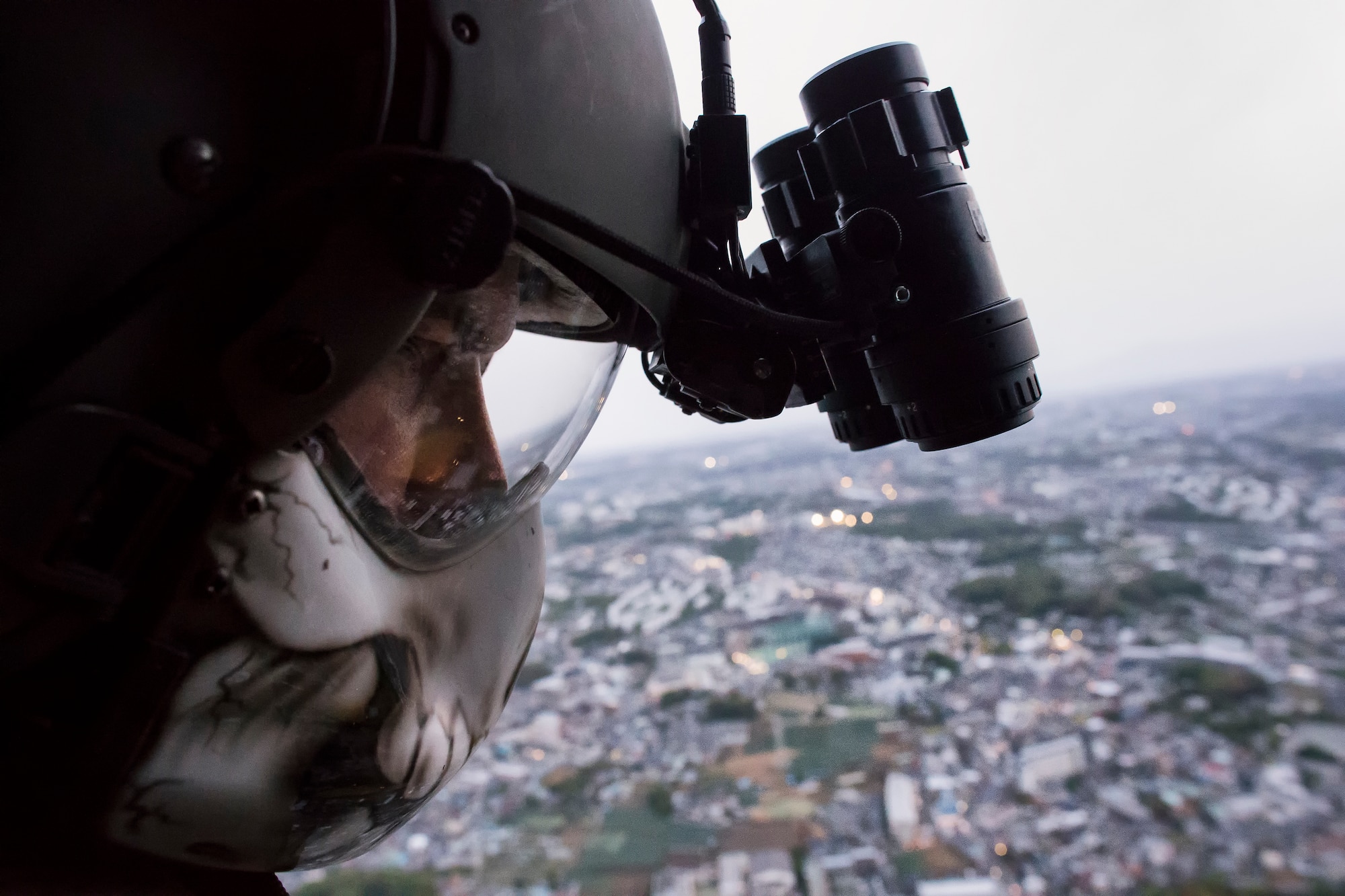 Tech. Sgt. Christopher Rector, 459th Airlift Squadron UH-1N special missions aviator evaluator, prepares to conduct hoist training over Yokohama, Kanagawa prefecture, Japan, April 25, 2016. Airmen with the 459 AS regularly practice their airlift capabilities in order to respond to regional contingencies. (U.S. Air Force photo by Yasuo Osakabe/Released)