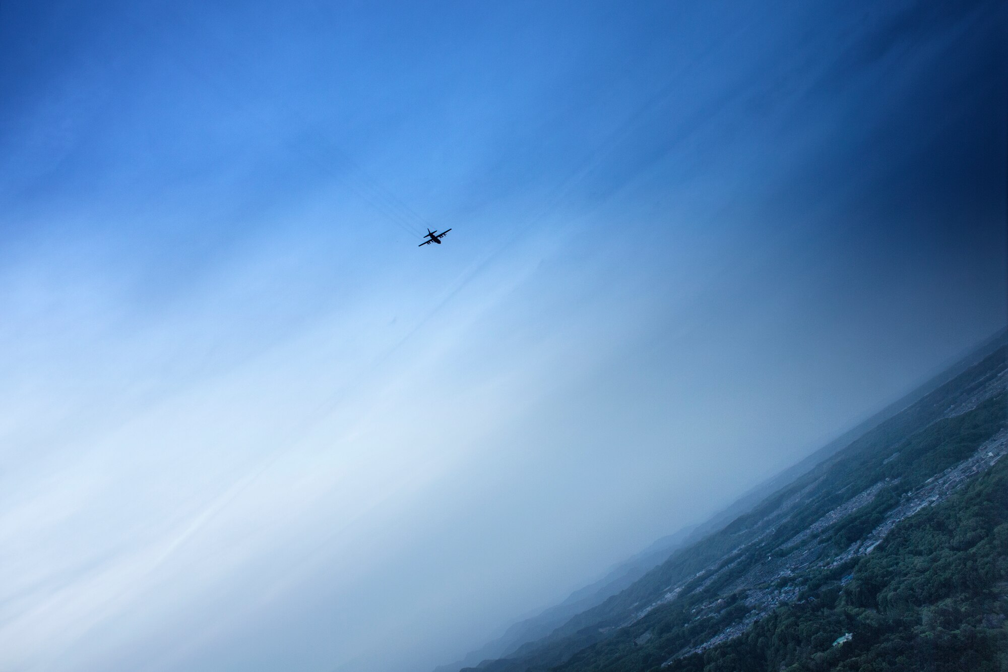 A C-130H Hercules assigned to the 36th Airlift Squadron flies over the Kanto Plain region, April 25, 2016, during a training flight. The 36 AS and 459th Airlift Squadron regularly conduct training missions to remain proficient the necessary skills to support any contingency. (U.S. Air Force photo by Yasuo Osakabe/Released)  