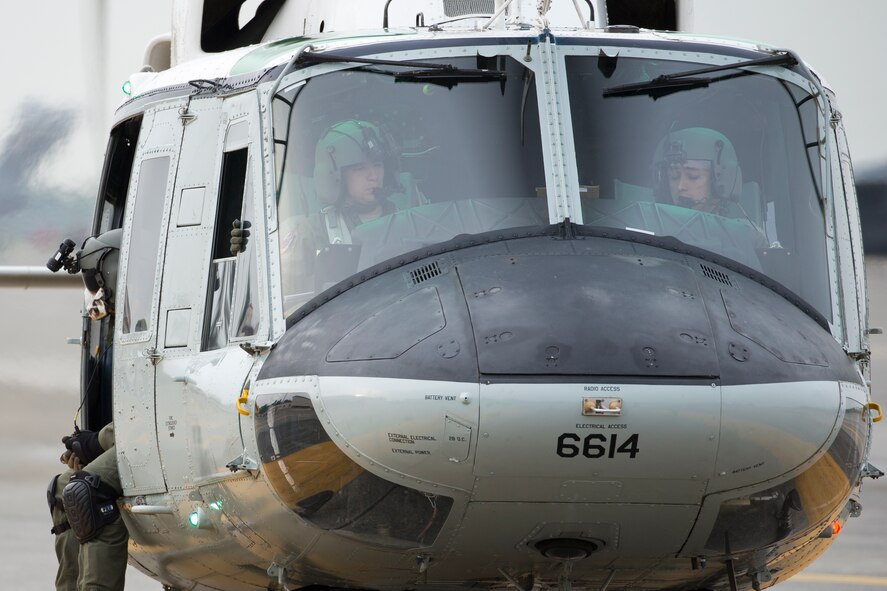 Crewmembers of a UH-1N Iroquois with the 459th Airlift Squadron take off at Yokota Air Base, Japan, April 25, 2016. The 459 AS regularly conducts training missions to keep their skills proficient. (U.S. Air Force photo by Yasuo Osakabe/Released)