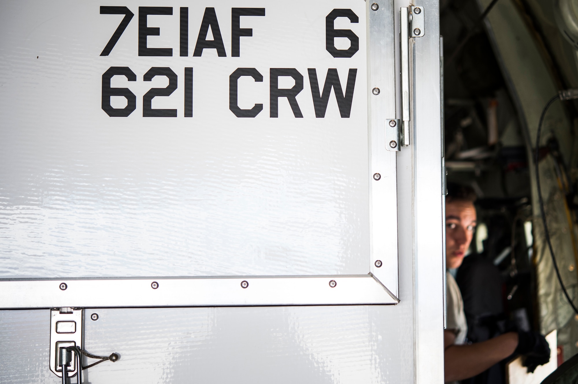 Senior Airman Christopher Williams, an aerial porter assigned to the 821st Contingency Response Group at Travis Air Force Base, Calif., attempts to walk through between a trailer and the inside of an aircraft during Cerberus Strike 16-01 at Fort Carson, Colo., April 24, 2016. More than 120 Airmen assigned to the 821st CRS participated in the nine-day joint exercise. (U.S. Air Force photo by Tech. Sgt. Gustavo Gonzalez/Released)