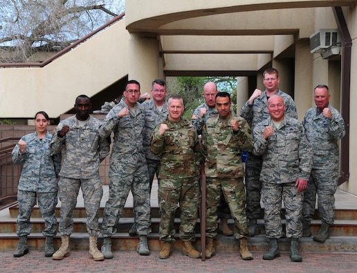 Army Command Sergeant Major John Wayne Troxell, Senior Enlisted Advisor to the Chairman of the Joint Chiefs of Staff and Chief Master Sergeant Mitchell Brush, Senior Enlisted Advisor for the National Guard Bureau, pose with fists up for a group photo with the Airmen and Soldier of the Year Award winners as well as other members of the New National Guard, on 15 April, 2016. Both SEAC’s offered mentorship and guidance as well as listening to the concerns of the members during their morning breakfast at the Thunderbird Inn located on Kirtland AFB, N.M. (Air National Guard Photo by Master Sgt. Paula Aragon)