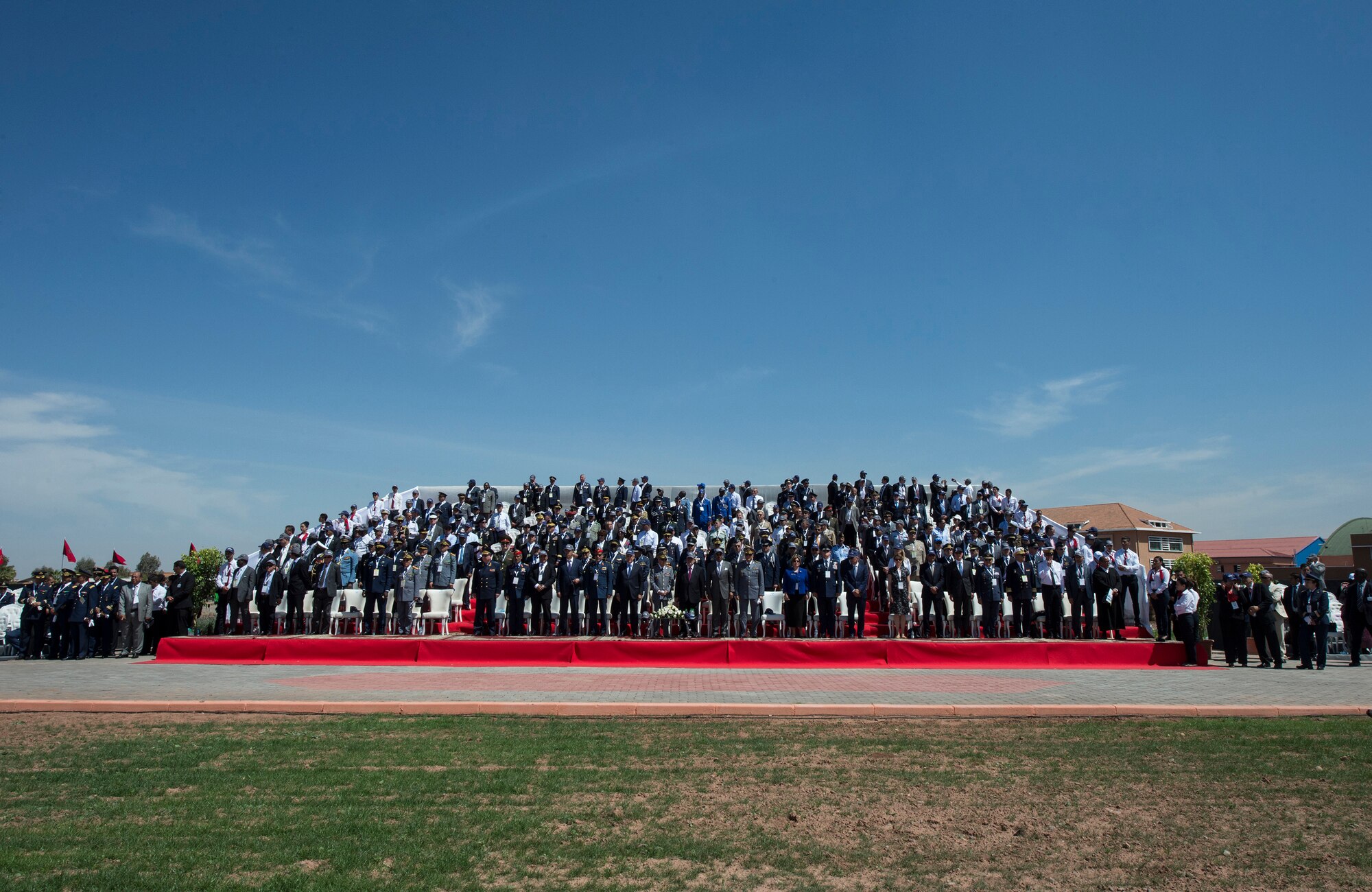 Individuals from approximately 54 countries stand during the playing of the Italian national anthem at the International Marrakech Airshow in Marrakech, Morocco on Apr. 27, 2016. Several U.S. independent and government owned aircraft were displayed at the expo in an effort to demonstrate their capabilities to a broad audience of individuals from around the world. (DoD News photo by TSgt Brian Kimball)