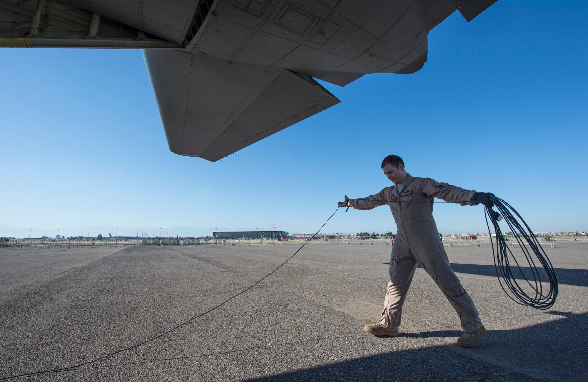 U.S. Air Force Staff Sergeant Joshua Shryock, a loadmaster with the 37th Airlift Squadron, recoyals aircraft electrical cord for a C-130J Hurcules during the International Marrakech Airshow in Morocco on Apr. 27 2016. TSgt Shryock is part of a six-man flight crew entrusted with transporting the aircraft to the airshow and showcasing the aircrafts capabilities for spectators. (DoD News photo by TSgt Brian Kimball)
