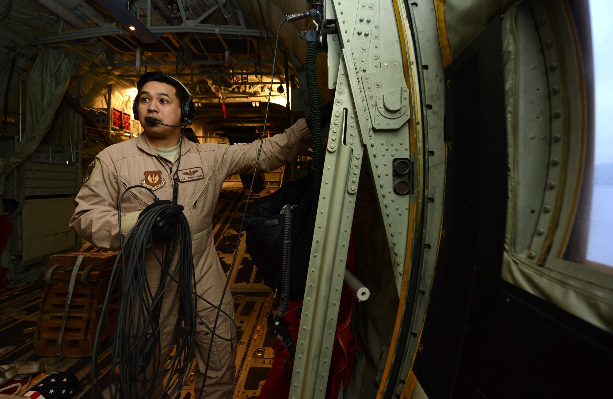 U.S. Air Force Technical Sergeant Gregory Flores, a loadmaster with the 37th Airlift Squadron (AS), communicates with the other aircrew during pre-flight checks on a C-130J Hercules prior to take off from Ramstein Air Base, Germany on Apr. 26, 2016. TSgt Flores is part of a six-man flight crew entrusted with transporting the aircraft to the 2016 International Marrakech Airshow in Morocco and showcasing the aircrafts capabilities. (DoD News photo by TSgt Brian Kimball)