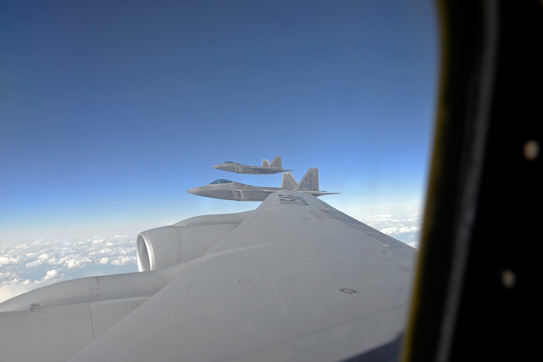 F-22A Raptors from the 95th Fighter Squadron, Tyndall Air Force Base, Florida, fly with a KC-135 Stratotanker from Seymour Johnson Air Force Base, N.C., over European skies before landing at Mihail Kogalniceanu Air Base, Romania, April 25, 2016. The aircraft will conduct air training with other Europe-based aircraft to maximize training opportunities while demonstrating the U.S. commitment to NATO allies and the security of Europe. (U.S. Air Force photo by Capt. Leah Davis/Released)