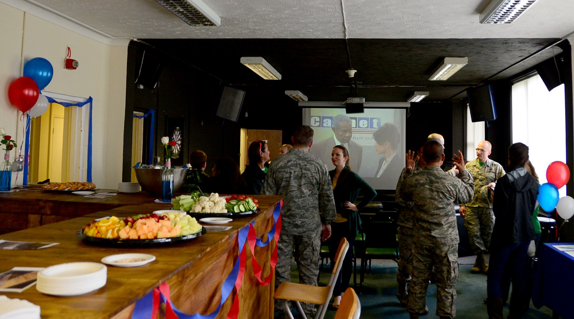 Airmen from the 48th Fighter Wing gather for a ribbon-cutting ceremony in the newly opened Airman Community Center at Royal Air Force Lakenheath, England, April 22. A ribbon-cutting ceremony was held to mark the opening of the new facility which provides dorm residents an enjoyable environment to make connections with other Airmen. (U.S. Air Force photo/Senior Airman Erin Trower)