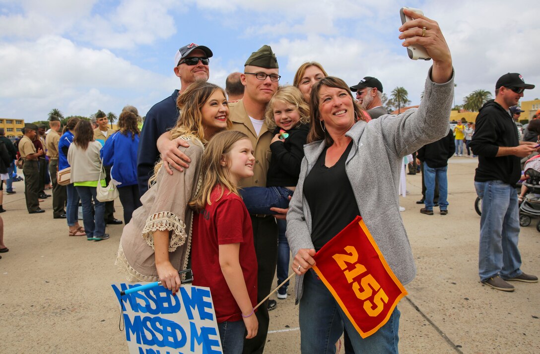 A Marine from Golf Company, 2nd Recruit Training Battalion, poses for a picture after being released for liberty at Marine Corps Recruit Depot San Diego, April 28. Family Day is the first time the new Marines are able to reunite with their families for the first time since leaving for Marine Corps recruit training. Annually, more than 17,000 males recruited from the Western Recruiting Region are trained at MCRD San Diego. Golf Company is scheduled to graduate April 29.
