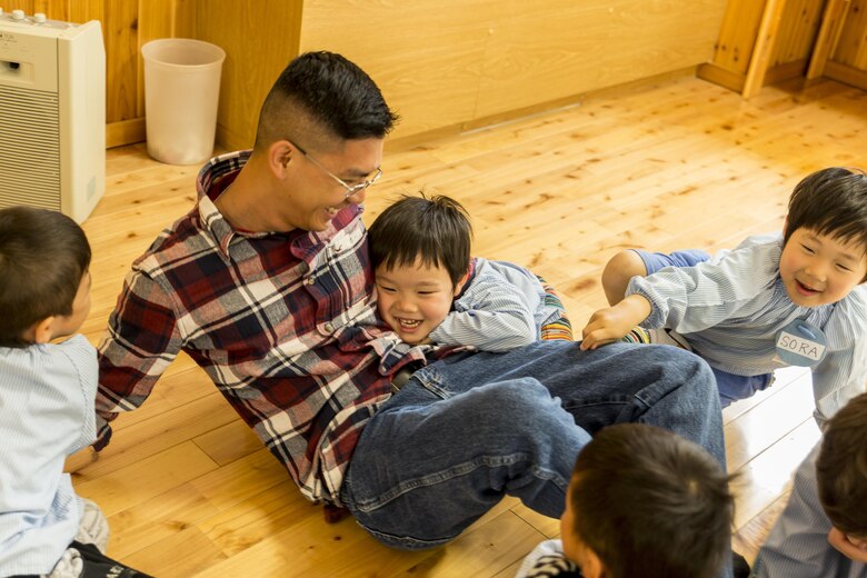 Seaman Thong Ho, shipping and receiving clerk with the distribution and management office on from Marine Corps Air Station Iwakuni, interacts with children at Josho Hoikuen School in Iwakuni City, Japan, April 19, 2016. Visiting the school provided service members the chance to teach children how to speak and count in English, fostering the friendship between the U.S. and Japan. (U.S. Marine Corps photo by Lance Cpl. Aaron Henson/Released)