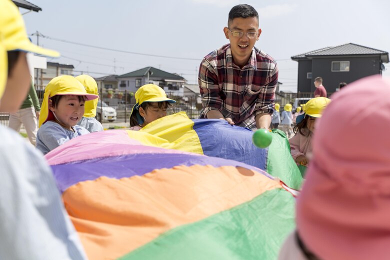 Seaman Thong Ho, shipping and receiving clerk with the distribution and management office on Marine Corps Air Station Iwakuni, plays with children at Josho Hoikuen School in Iwakuni City, Japan, April 19, 2016. Interaction with the school and community helps continue an important relationship between the U.S. and Japanese. (U.S. Marine Corps photo by Lance Cpl. Aaron Henson/Released)