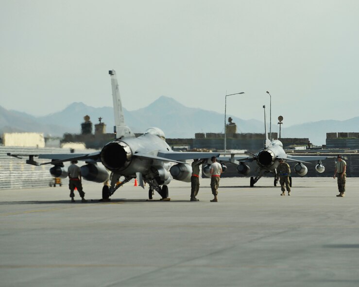 A pair of F-16 Fighting Falcons assigned to the 457th Expeditionary Fighter Squadron get inspected by maintenance personnel shortly after landing at Bagram Airfield, Afghanistan. The F-16 is a multi-role fighter aircraft that is capable of providing close air support to U.S. and coalition forces on the ground throughout Afghanistan. (U.S. Air Force photo by Capt. Korey Fratini/released)