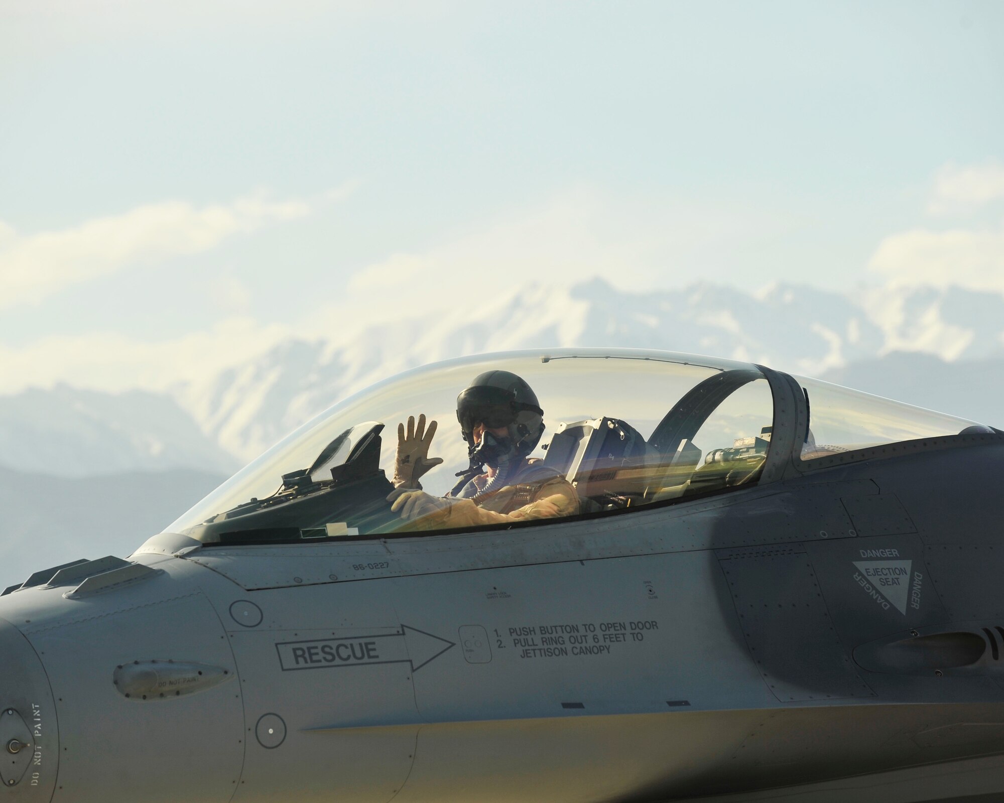 An F-16 pilot from the 457th Expeditionary Fighter Squadron waves as he taxis his aircraft after arriving to Bagram Airfield, Afghanistan, 27 April, 2016. The 457th EFS provides overwatch and close air support to U.S. and coalition ground forces throughout the Afghanistan area of operation. (U.S. Air Force photo by Capt. Korey Fratini/released). 