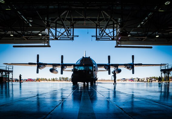 Crew chiefs with the Wyoming Air National Guard’s 153rd Maintenance Group tow an aircraft inside a hangar to facilitate maintenance April 21, 2016 in Cheyenne, Wyo. Maintainers must tow the aircraft in the hangar when wind gusts are above maximum limits to perform certain types of repairs. (U.S. Air National Guard photo/Master Sgt. Charles Delano)
