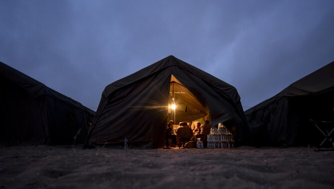 Military members participating in exercise African Lion 16 gather inside a tent at the end of the day in Tifnit, Morocco, April 23, 2016. Of the 11 nations participating in the annual exercise were a group of U.S. military members, Royal Moroccan Armed Forces members, Spanish Legion soldiers and Royal Netherlands Army soldiers. They lived in field conditions and participated in daily familiarization with other nations’ tactics to improve interoperability. (U.S. Air Force photo/Senior Airman Krystal Ardrey)