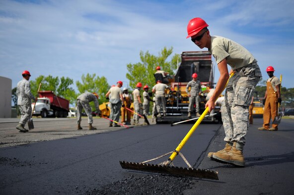 Airman 1st Class Bryan Daniel, a heavy equipment operator with the 823rd RED HORSE Squadron, sifts freshly laid asphalt to the proper depth at Hurlburt Field, Fla., April 20, 2016. As part of a two-week milling and paving training course, more than 20 Airmen from across the globe participated by laying asphalt to repair a parking lot. (U.S. Air Force photo/Airman 1st Class Joseph Pick)