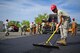 Airman 1st Class Bryan Daniel, a heavy equipment operator with the 823rd RED HORSE Squadron, sifts freshly laid asphalt to the proper depth at Hurlburt Field, Fla., April 20, 2016. As part of a two-week milling and paving training course, more than 20 Airmen from across the globe participated by laying asphalt to repair a parking lot. (U.S. Air Force photo/Airman 1st Class Joseph Pick)