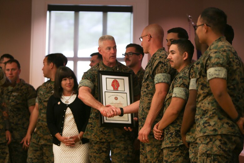 Major Gen. Brian Beaudreault, commanding general of 2nd Marine Division, congratulates 1st Sgt. Joshua Nodarft, a company first sergeant with 1st Battalion, 2nd Marine Regiment, for the hard work and volunteer hours put in by the Marines in his company during a ceremony held at Camp Lejeune, N. C., April 27, 2016. The ceremony was held in honor of National Volunteer Month.  (U.S. Marine Corps photo by Cpl. Melodie Snarr/Released)
