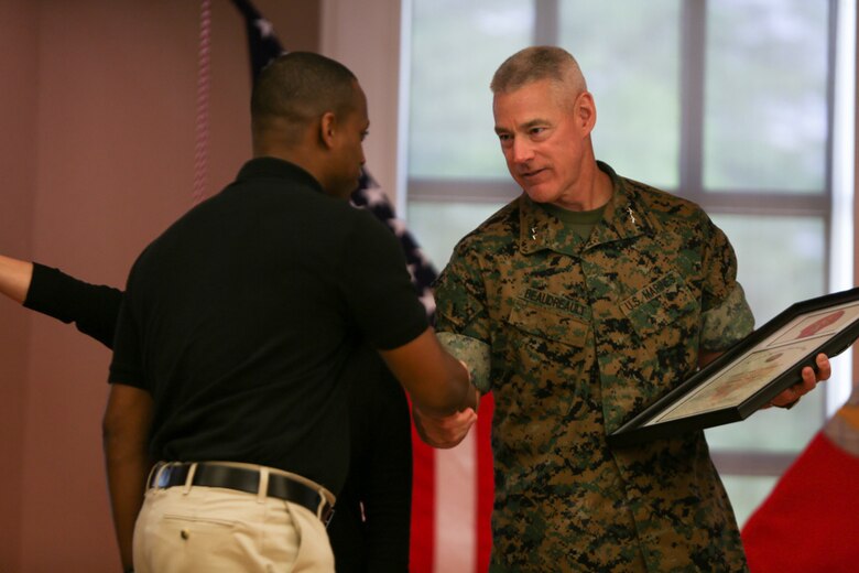 Major Gen. Brian Beaudreault, commanding general of 2nd Marine Division, commemorates Staff Sgt. Terrance Shorty, the career planner for 3rd Battalion, 6th Marine Regiment, for his hard work and dedication to volunteering with the Marines in his unit, during a ceremony held at Camp Lejeune, N. C., April 27, 2016. The 2nd Marine Division honored numerous Marines from all around its units for giving their time back to the community. (U.S. Marine Corps photo by Cpl. Melodie Snarr/Released)