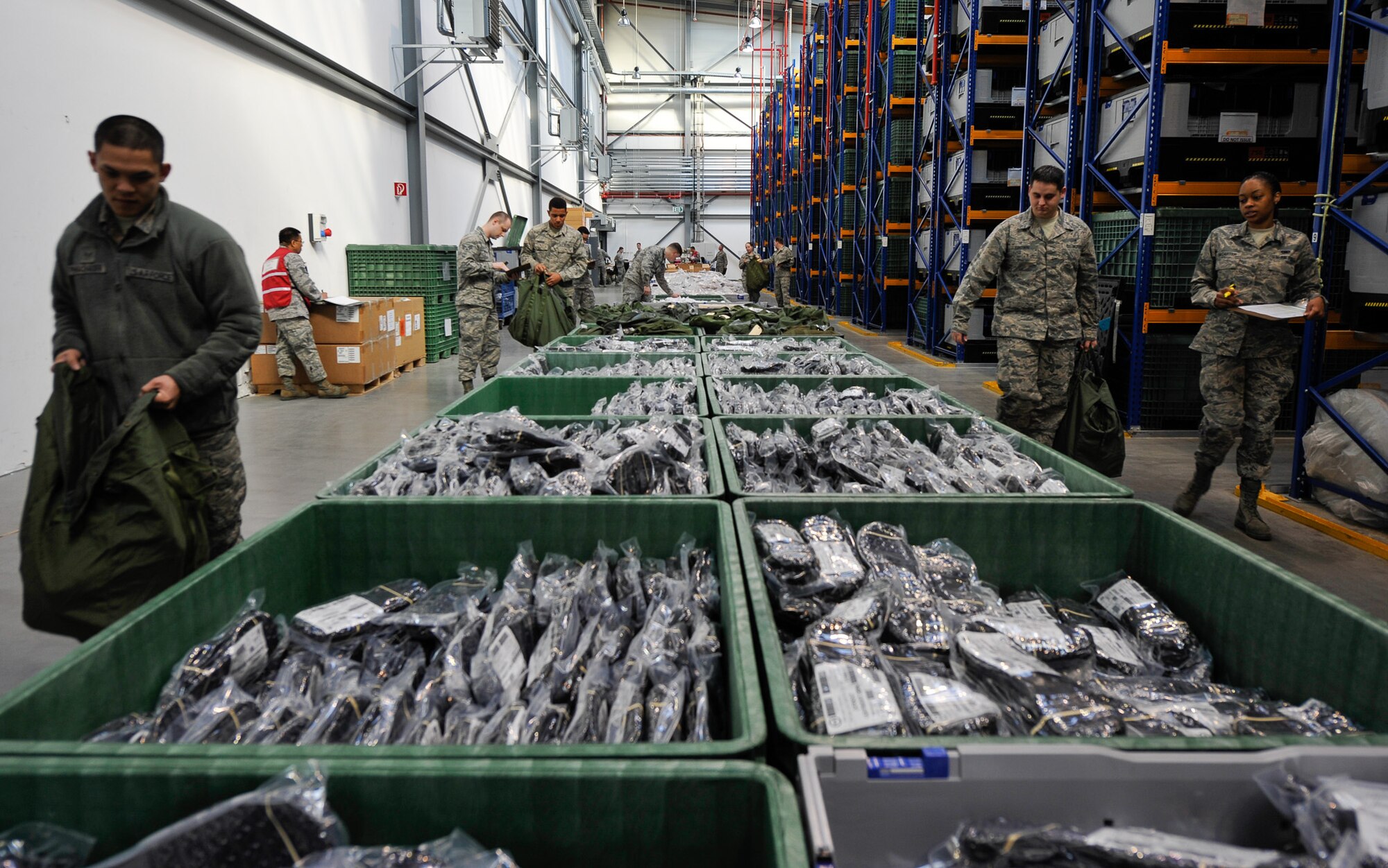 Personnel from the 86th Medical Group transition down the assembly line and are issued their individual protective equipment by the 86th Logistics Readiness Squadron during Wing Thunder April 20, at Ramstein Air Base, Germany. The goal of the LRS is to ensure each member has all their required gear in the correct sizes so they are mission ready. (U.S. Air Force photo/Staff Sgt. Leslie Keopka)