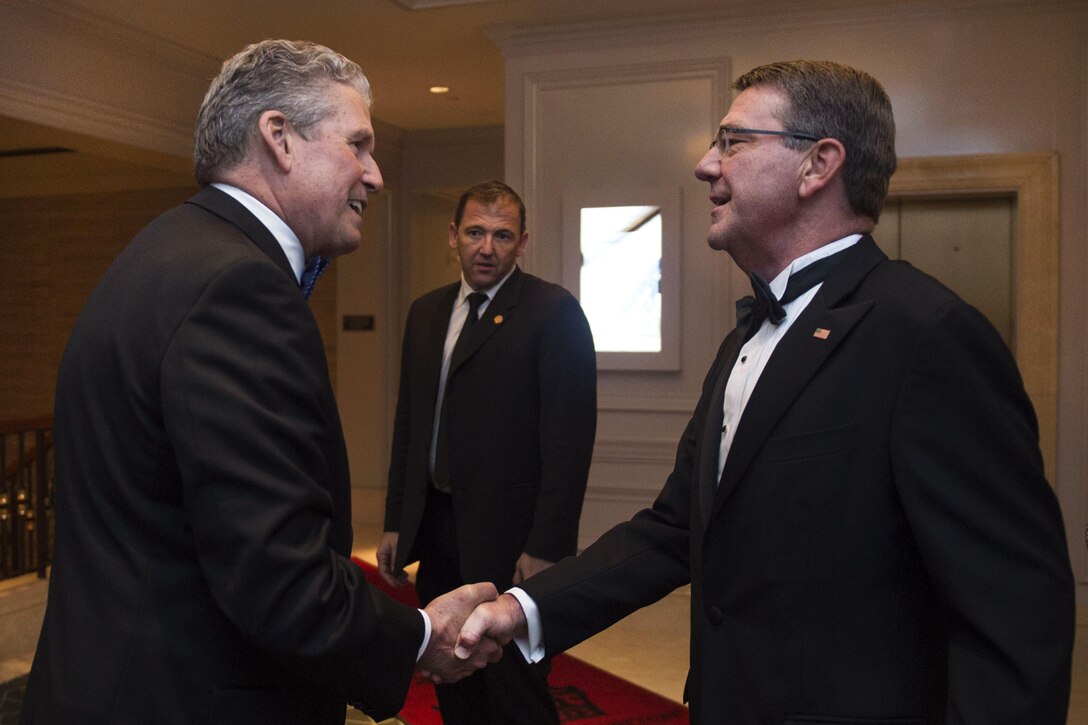 Defense Secretary Ash Carter, right, is greeted by Business Executives for National Security Chief Operating Officer Henry Hinton as he arrives for the BENS Eisenhower Award dinner in Washington D.C., April 28, 2016. Carter was presented the 2016 Eisenhower Award. DoD photo by Senior Master Sgt. Adrian Cadiz