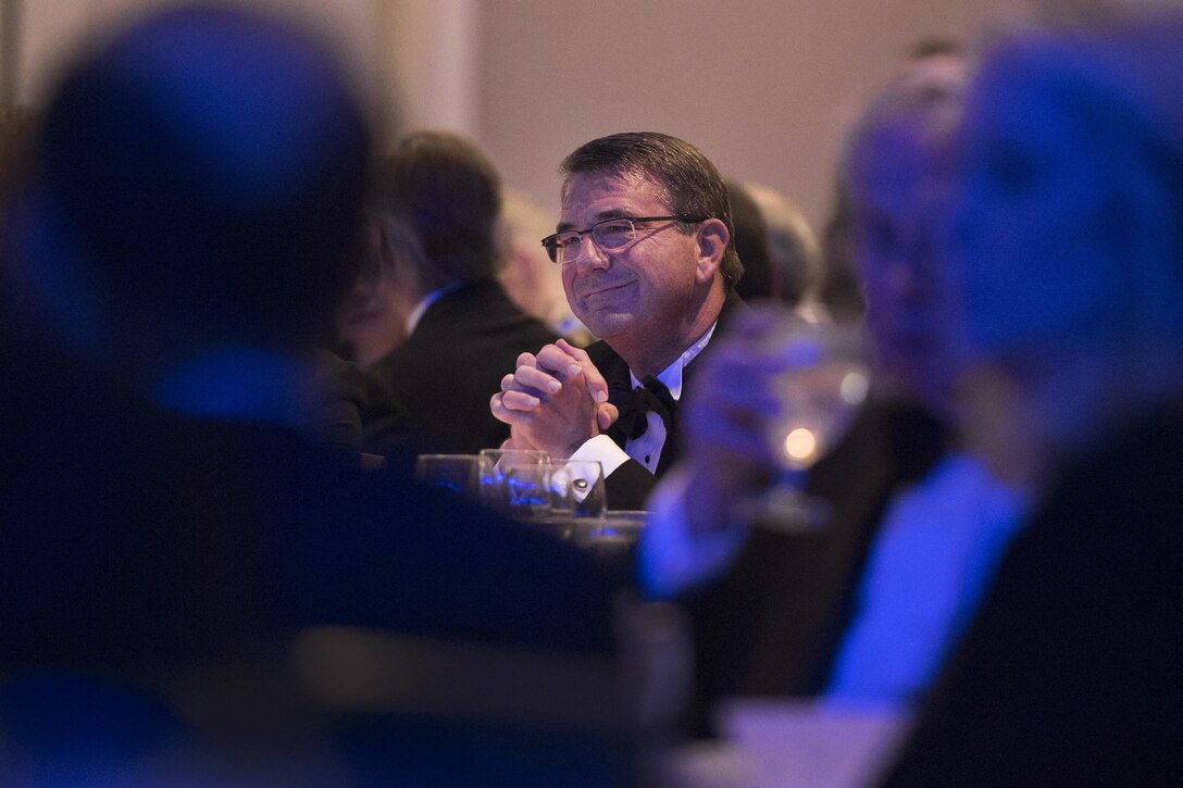 Defense Secretary Ash Carter, center, listens as Retired Air Force Gen. Norton A. Schwartz, President & Chief Executive Officer for the Business Executives for National Security, delivers remarks at the BENS Eisenhower Award dinner in Washington D.C., Apr. 28, 2016. Carter was presented with the 2016 Eisenhower Award. DoD photo by Senior Master Sgt. Adrian Cadiz