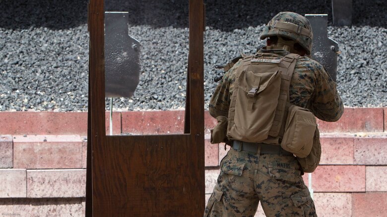 U.S. Marine Corps Lance Cpl. Lucas Matos, a rifleman with Special Purpose Marine Air-Ground Task Force-Crisis Response-Africa, fires through a window frame during a stress shooting exercise held by U.S. Army Special Forces in Germany, Apr. 12, 2016. The Marines ran through a timed firing course filled flash-bang grenades and challenging shooting positions to put their marksmanship skills to the test in a stressful environment. After the course of fire, the squads ran as a team to the Military Operations on Urban Terrain town to complete a speed and agility course. 