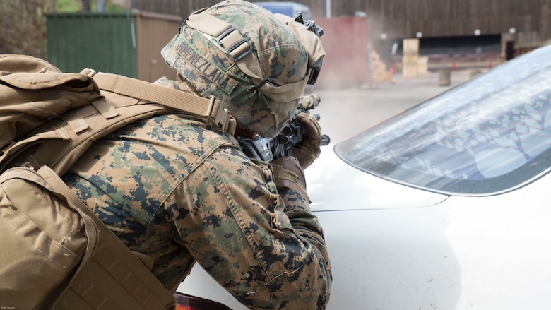 U.S. Marine Corps Lance Cpl. Manuel JimenezLara, a rifleman with Special Purpose Marine Air-Ground Task Force-Crisis Response-Africa, fires at a target from behind the cover of a vehicle during a stress shooting exercise held by U.S. Army Special Forces in Germany, Apr. 12, 2016. The Marines ran through a timed firing course with flash-bang grenades and challenging shooting positions to put their marksmanship skills to the test in a stressful environment. After the course of fire, the squads ran as a team to the Military Operations on Urban Terrain town to complete a speed and agility course. 