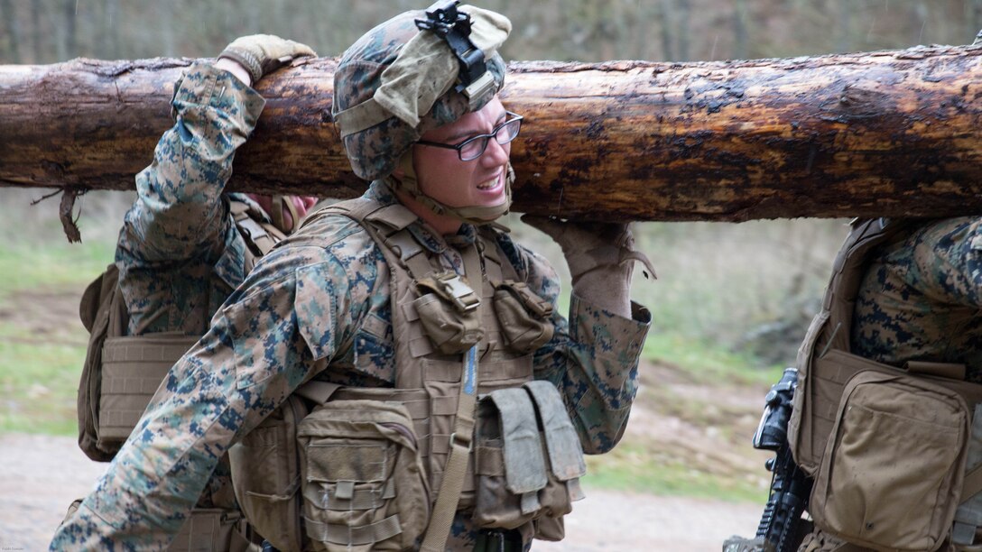 U.S. Marine Corps Lance Cpl. Matthew Pfaff, a team leader with Special Purpose Marine Air-Ground Task Force-Crisis Response-Africa, carries a log with his squad across steep terrain for the final exercise of a stress event held by U.S. Army Special Forces in Germany, Apr. 12, 2016. The stress event consisted of a timed firing course, an urban agility course and a squad log run to test the Marines’ speed and endurance under stressful conditions. 