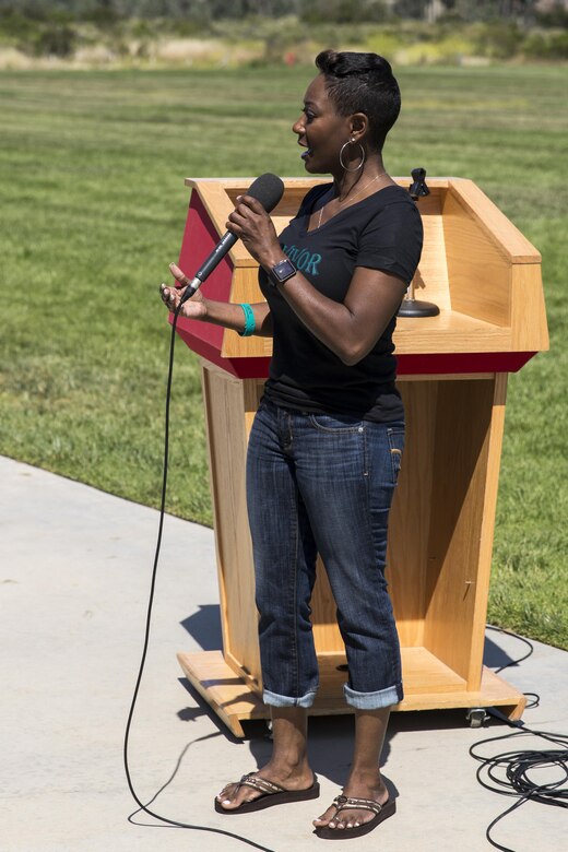 Staff Sgt. Julia Edwards, G-4 operations chief with Headquarters Regiment, 1st Marine Logistics Group, speaks to those that participated at the 2016 Sexual Assault Prevention and Response Walk aboard Marine Corps Air Station Miramar, Calif., April 22. Edwards used her personal experience to help convey the importance of eliminating sexual assault not only in the military, but society as a whole. (U.S. Marine Corps photo by Sgt. Michael Thorn/Released)