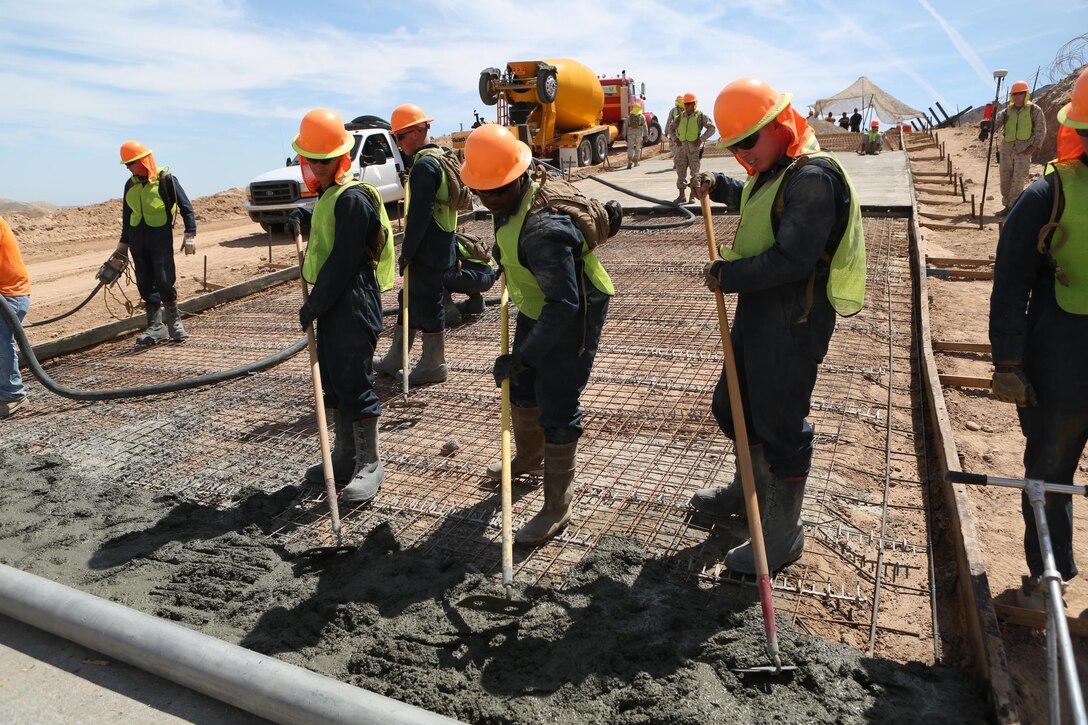 U.S. Marines with 7th Engineer Support Battalion assist in the pouring of concrete during a road improvement project with Joint Task Force North in El Centro, Calif., April 19, 2016. For the last two months, the Marines have been processing and leveling dirt to improve the road’s quality as well as constructing low-water crossings to maintain the integrity of the road during wet conditions. (U.S. Marine Corps photo by Cpl. Carson Gramley/released)