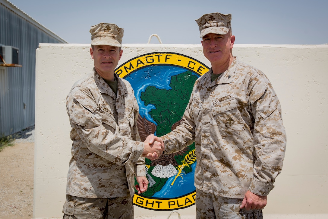 U.S. Marine Corps Col. William Mccollough, left, the former commanding officer of the Special Purpose Marine Air-Ground Task Force Crisis Response-Central Command (SPMAGTF-CR-CC), shakes hands with Col. Kenneth Kassner, the commanding officer of the incoming SPMAGTF-CR-CC, in an undisclosed location, Southwest Asia, April 23, 2016. (U.S. Marine Corps photo by Cpl. Trever A. Statz/Released)