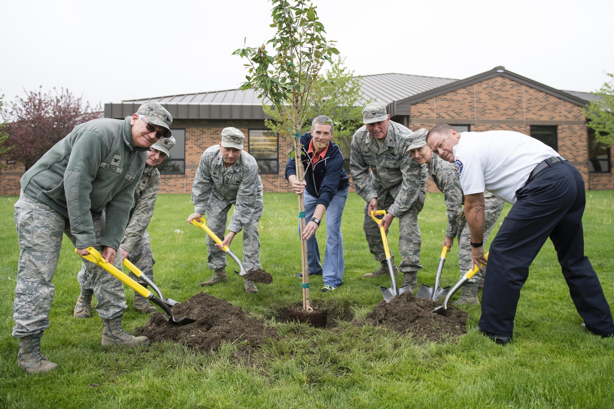 Grissom employees plant a Kwanzan cherry tree at Grissom Air Reserve Base, Ind., April. 29, 2016. From the left, they are Col. Anna Schulte, 434th Maintenance Group commander, Maj. Denney Neace, 434th Communications Squadron commander, Col. Scott Russell, 434th Mission Support Group commander, Cory Walters, 434th Civil Engineer Squadron biological scientist, Col. Doug Schwartz, 434th Air Refueling Wing commander, Col. Therese Kern, 434th Aerospace Medicine Squadron commander and John Ireland, Grissom fire chief. (U.S. Air Force photo/Tech. Sgt. Benjamin Mota) 