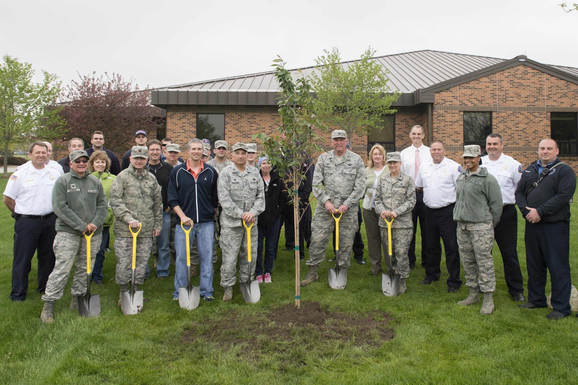 Grissom employees pose for a photo in front of a Kwanzan Cherry tree after a ceremony at Grissom Air Reserve Base, Ind., April 29, 2016 celebrating Arbor Day. Each year Arbor Day is celebrated on the last Friday of April and provides an opportunity to learn about trees and take positive action to make the world a better place. (U.S. Air Force photo/Tech. Sgt. Benjamin Mota)