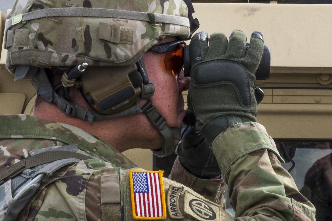 Army Staff Sgt. Brandon Herron uses binoculars to observes one of his soldiers during an M2 .50-caliber machine gun range at Joint Base Elmendorf-Richardson, Alaska, April 26, 2016. Herron is a paratrooper assigned to the 25th Infantry Division’s 40th Cavalry Regiment, 4th Brigade Combat Team (Airborne), Alaska. Air Force photo by Justin Connaher