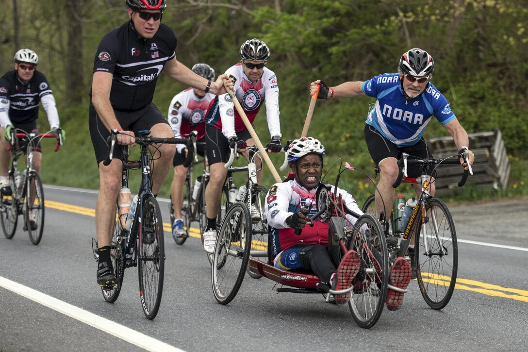 Retired Army Sgt. 1st Class Carl Morgan powers a handcycle with help from his teammates during the Face of America bike ride in Dickerson, Md., April 23, 2016. DoD photo by EJ Hersom
